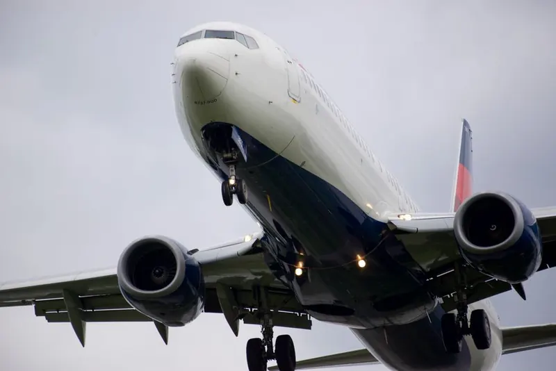 Airliner with landing gear down passing overhead on the Heathrow approach