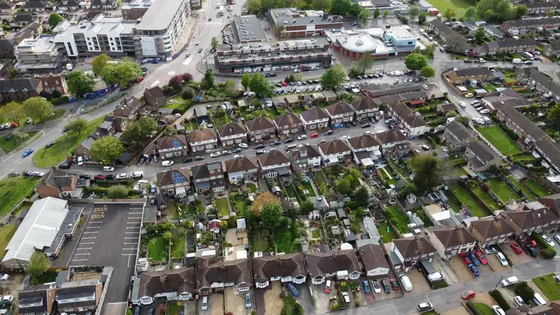 Aerial view of interwar semi-detached houses with single-storey rear extensions in an outer London suburb