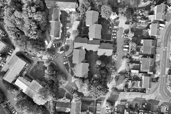 Aerial view of a suburban estate showing pitched roof slopes meeting at valleys