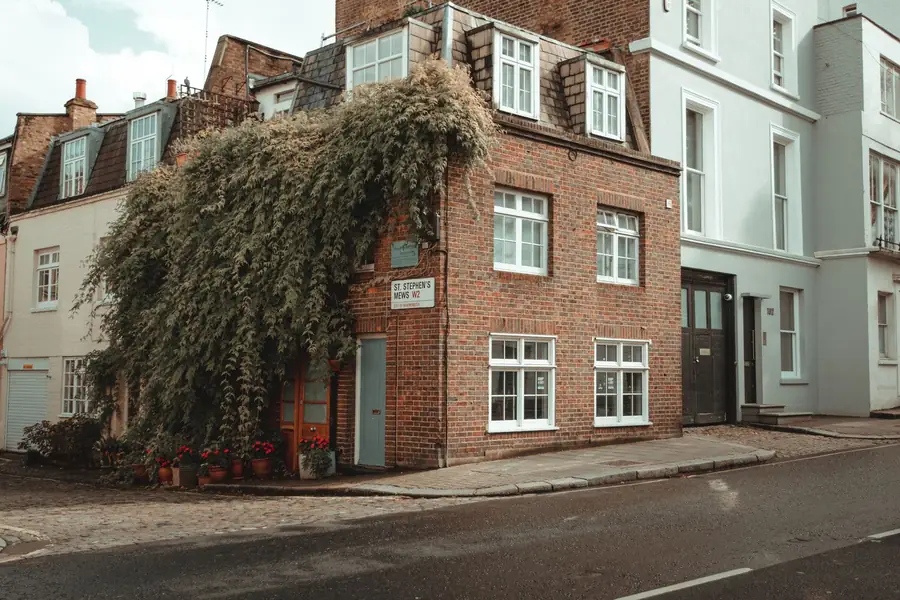 A London period brick house with slate roof and traditional dormers on a quiet street, the kind of home that needs an experienced roofer
