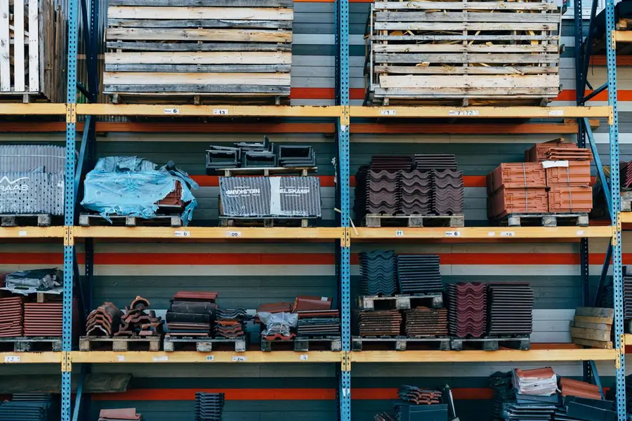 Pallets of new roof tiles stacked on racking at a builders merchant