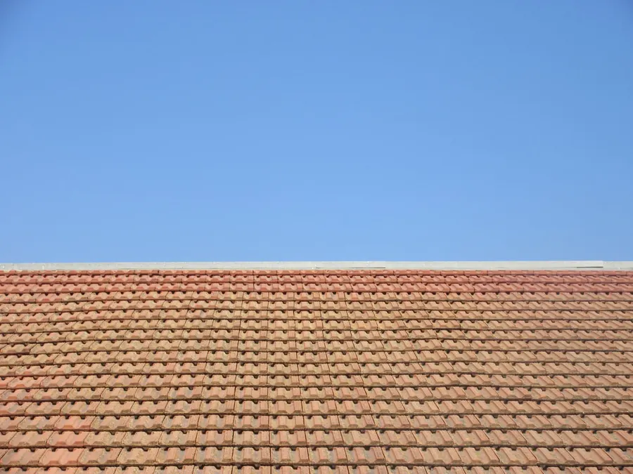 Close-up of a clay plain tile roof, the kind of handmade or sand-faced tile a Richmond conservation area re-roof has to match