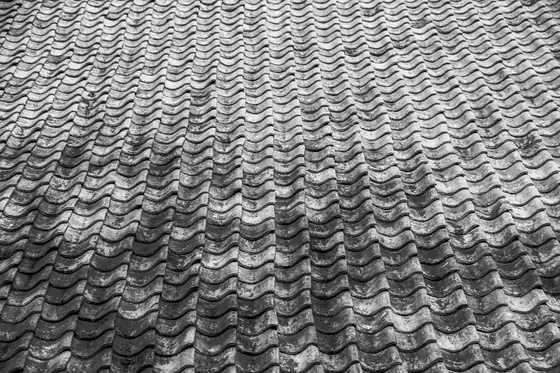 Rows of weathered concrete interlocking roof tiles of the kind used on postwar houses in Feltham