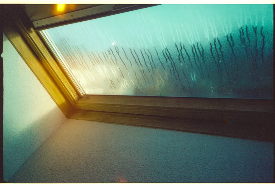 Condensation running down the inside of a rooflight in a converted loft