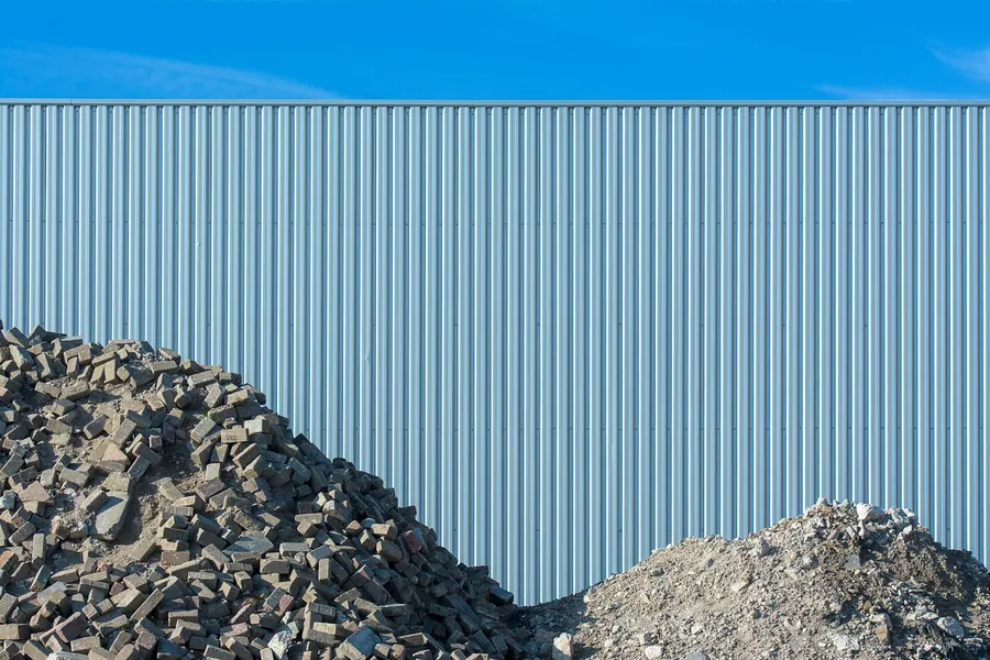 Heaps of broken brick and crushed rubble stacked at a waste transfer yard