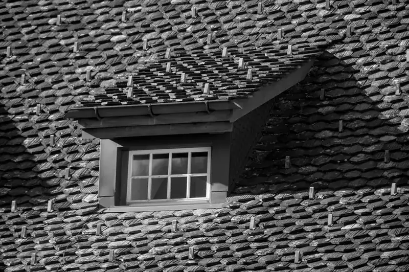 Dormer window set into an aged tiled roof slope