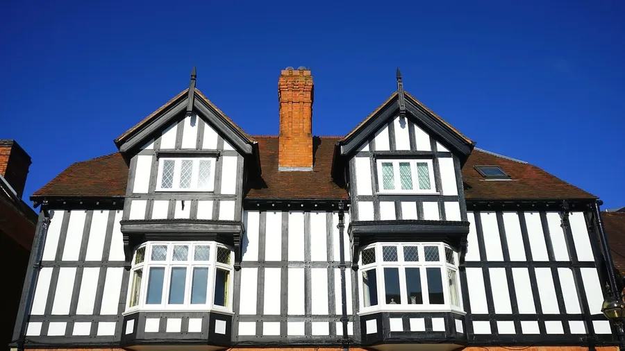 A half-timbered house with twin gables, tiled roof, bay windows and a brick chimney, the style found on many Jersey Road houses near Osterley