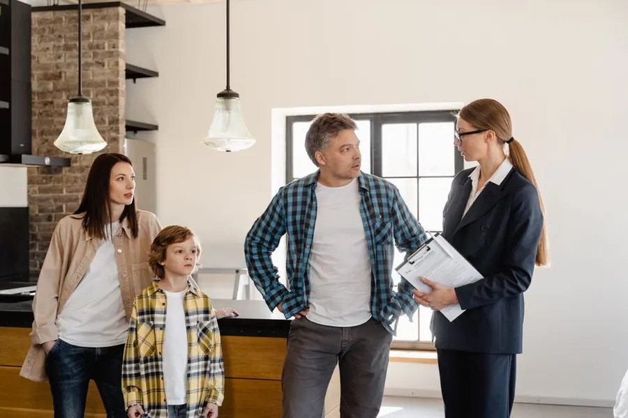 Homeowners talking through paperwork with a contractor