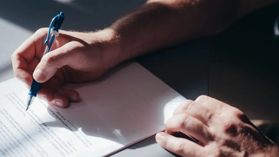 Homeowner writing a formal complaint about a refused roof insurance claim