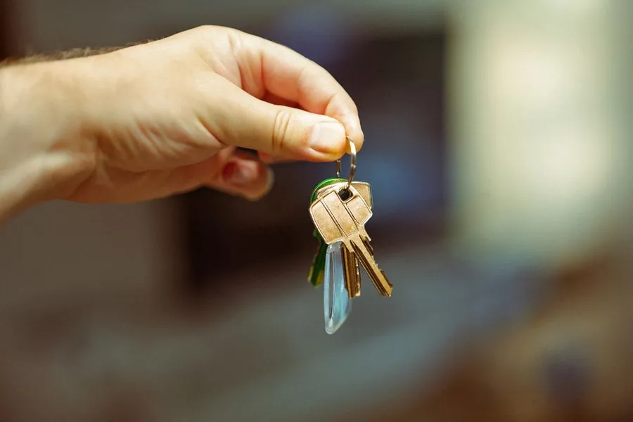 Set of house keys held up after a property purchase in west London