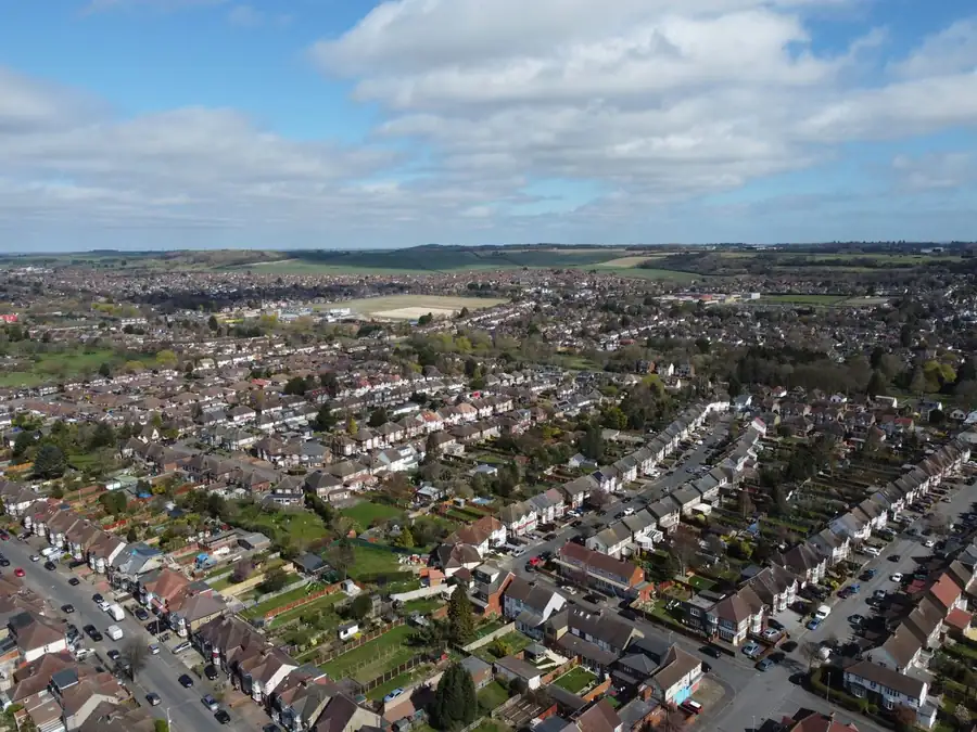 Aerial view of an interwar suburb of hipped-roof semi-detached houses, similar to the streets of Heston and Whitton