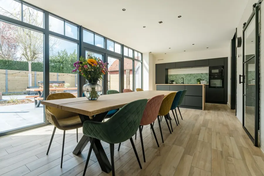 Open-plan kitchen and dining extension with glazed doors to the garden