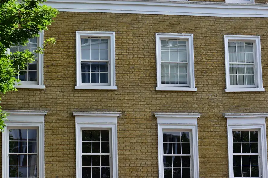 London stock brick facade with white painted sash windows, the glazing type Heathrow's insulation scheme covers