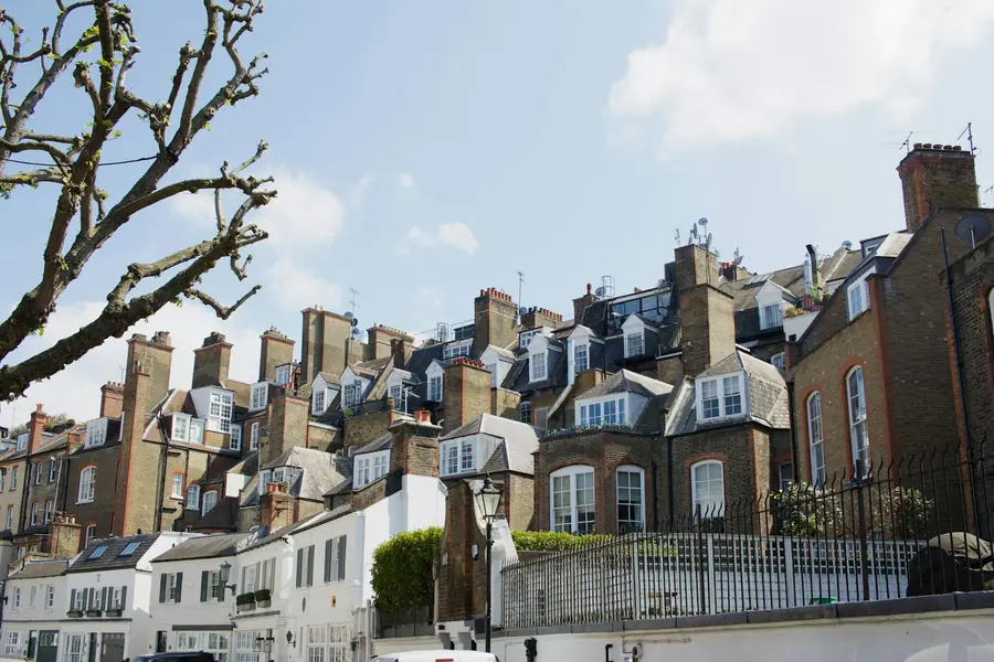 London rooftops crowded with mansard dormers and brick chimney stacks, the kind of roof alterations that need consent in Chiswick conservation areas