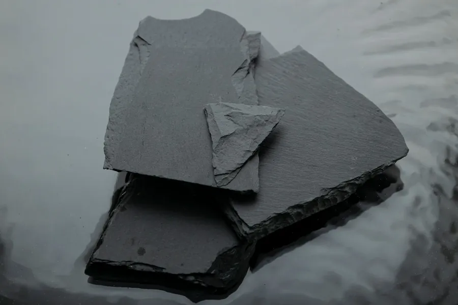 Pieces of natural grey slate ready for a like-for-like roof repair in Hounslow