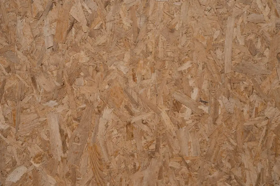 Close-up of an OSB board of the kind used as a new flat roof deck