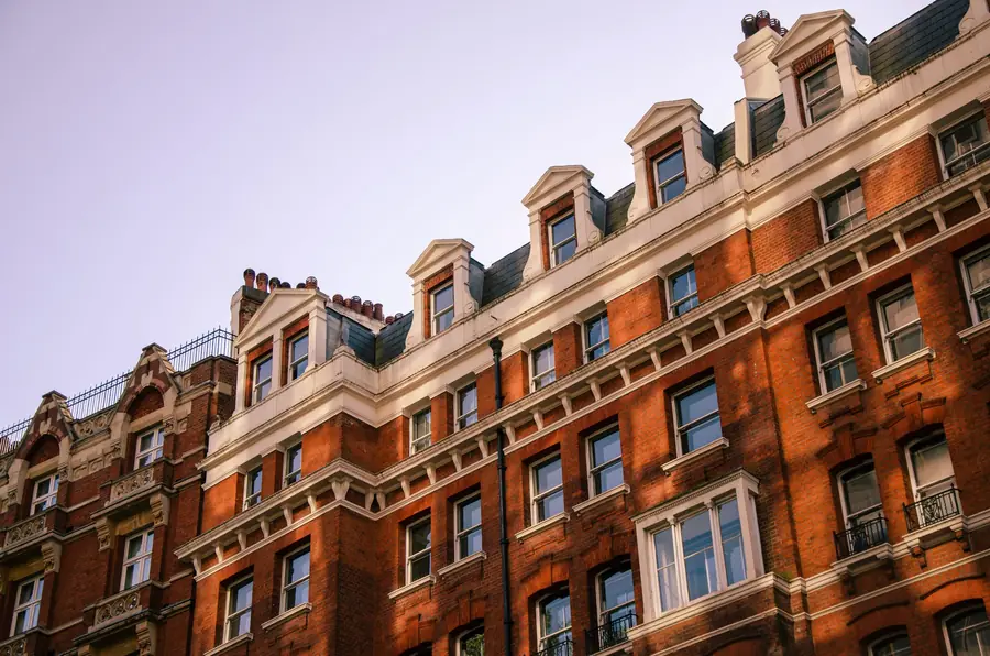 Red-brick Victorian mansion block with a slate mansard and dormers, typical of the taller stock around Richmond and East Twickenham