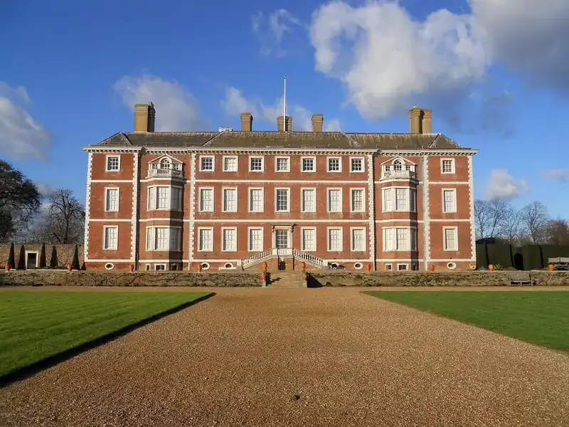 A seventeenth-century red brick house with a hipped roof, dormers and tall chimneys, typical of the older listed buildings near the Thames