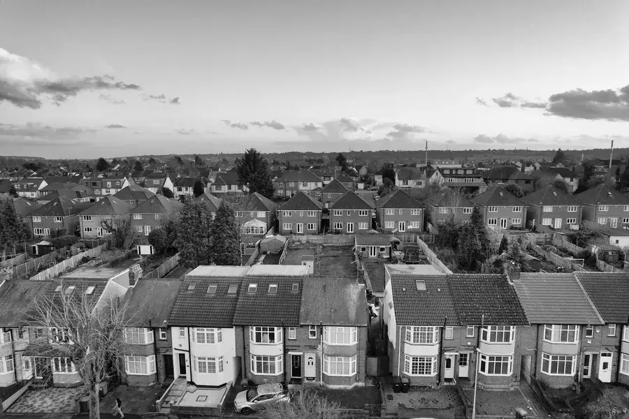 Aerial view of interwar semi-detached and terraced rooftops on a west London suburban street