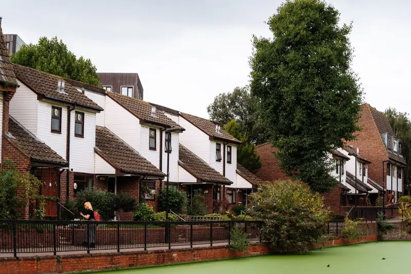 Row of London houses with concrete tiled roofs under an overcast sky