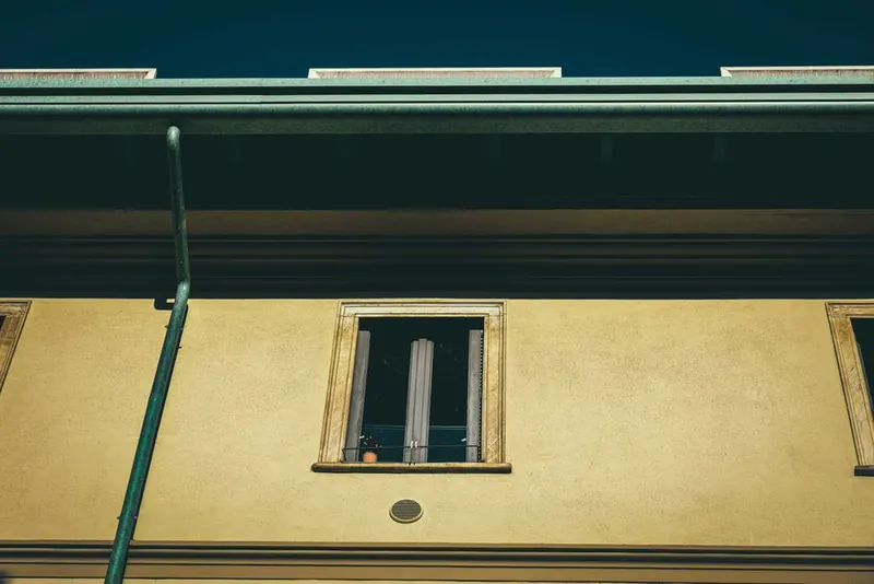 Gutter and deep eaves running along the top of a rendered frontage