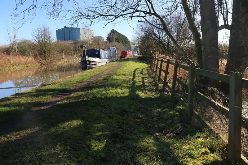 Narrowboats moored along the tree-lined Grand Union Canal near Hayes