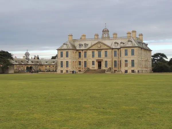 Grand nineteenth-century mansion with arched windows overlooking parkland lawns