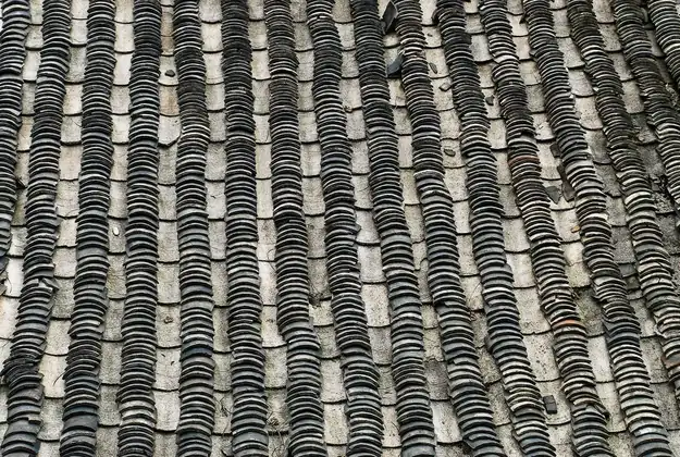 Weathered slate-grey tiles covering the roof of an older west London house