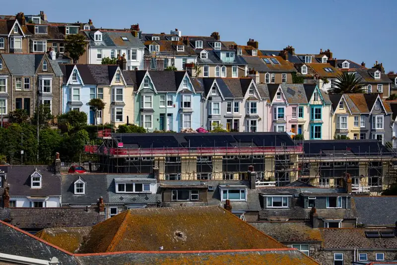 Scaffolding erected along the roofline of a terrace mid-repair