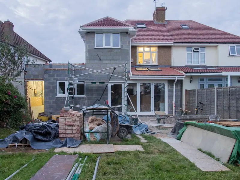Building work under way on the rear roof of a semi-detached house