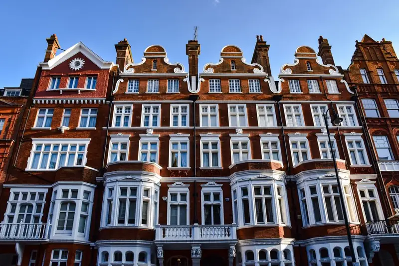 Ornate red-brick Victorian buildings with white stone detailing