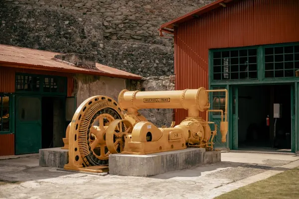 Restored Victorian pumping machinery outside an industrial museum building