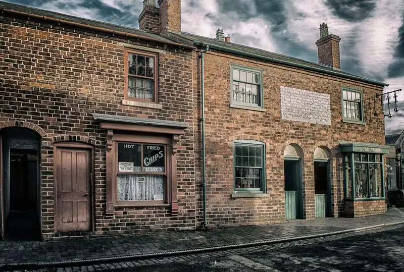 Historic brick buildings with varied old rooflines along a narrow market town street